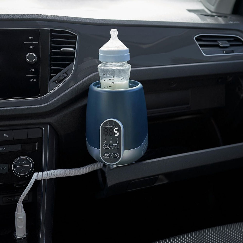 Babymoov Duo Smart Bottle Warmer, blue, mounted in car cup holder with baby bottle.