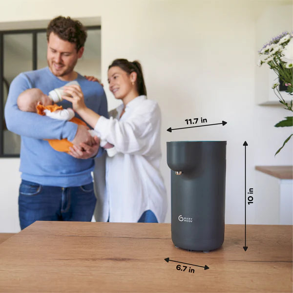 Babymoov Instant Baby Bottle Warmer Milky Now; gray countertop warmer with a smiling family in background