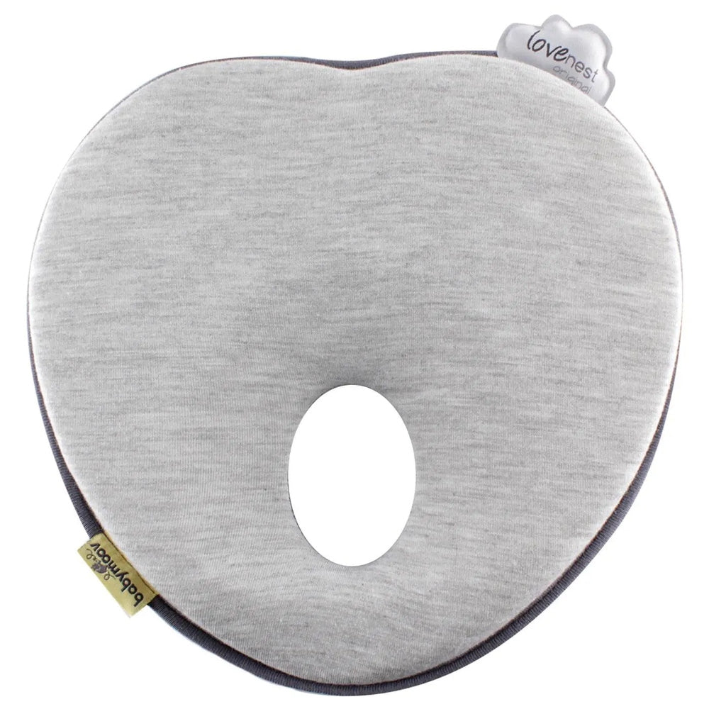 Babymoov Lovenest Pillow in light gray fabric with heart tag, curved baby-neck support for feeding.