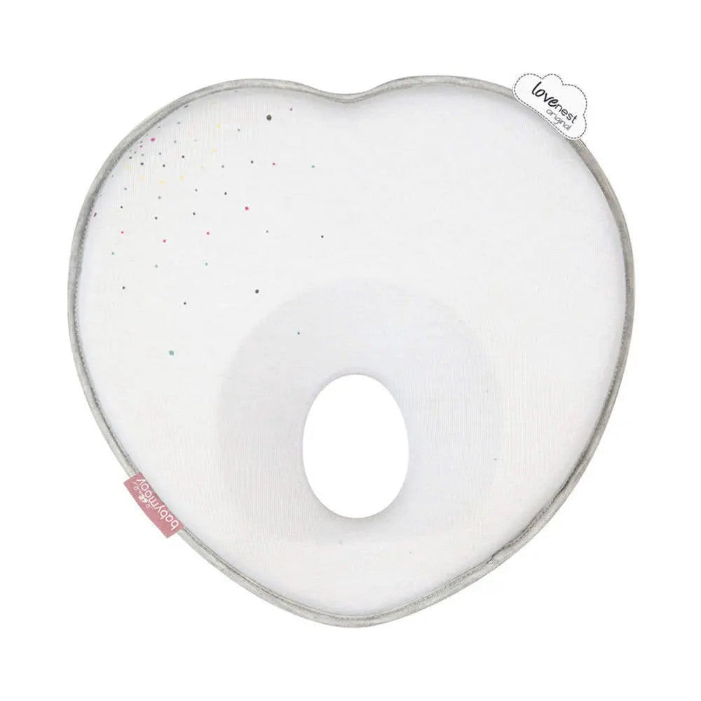Babymoov Lovenest Pillow white heart-shaped nursing cushion with speckled pattern, shown resting flat to support feeding.