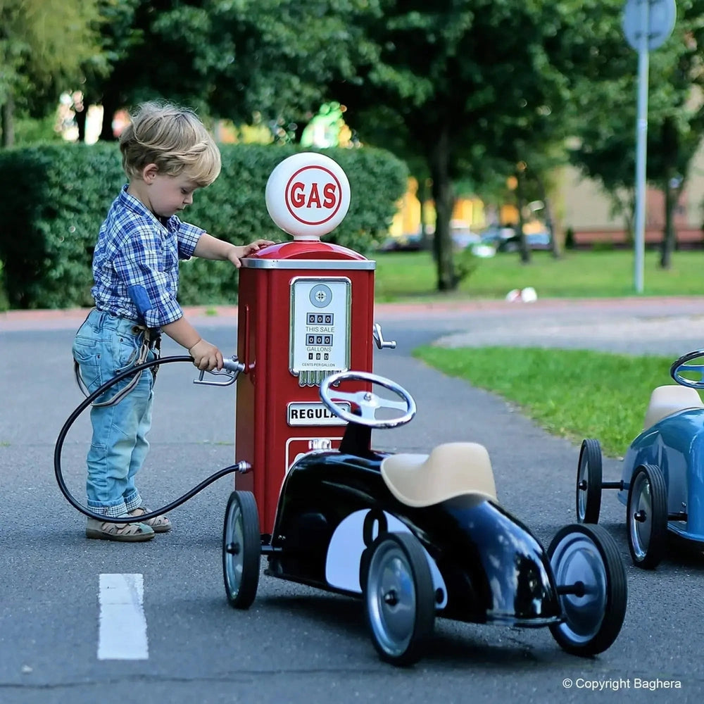 BAGHERA Play Gas Station Pump, red vintage push‑and‑pedal riding toy, as a child pumps gas with the hose.