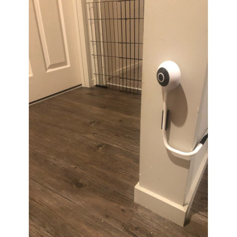 BBLUV wifi baby monitor mounted on a white pillar with circular camera; wood floor and metal gate visible