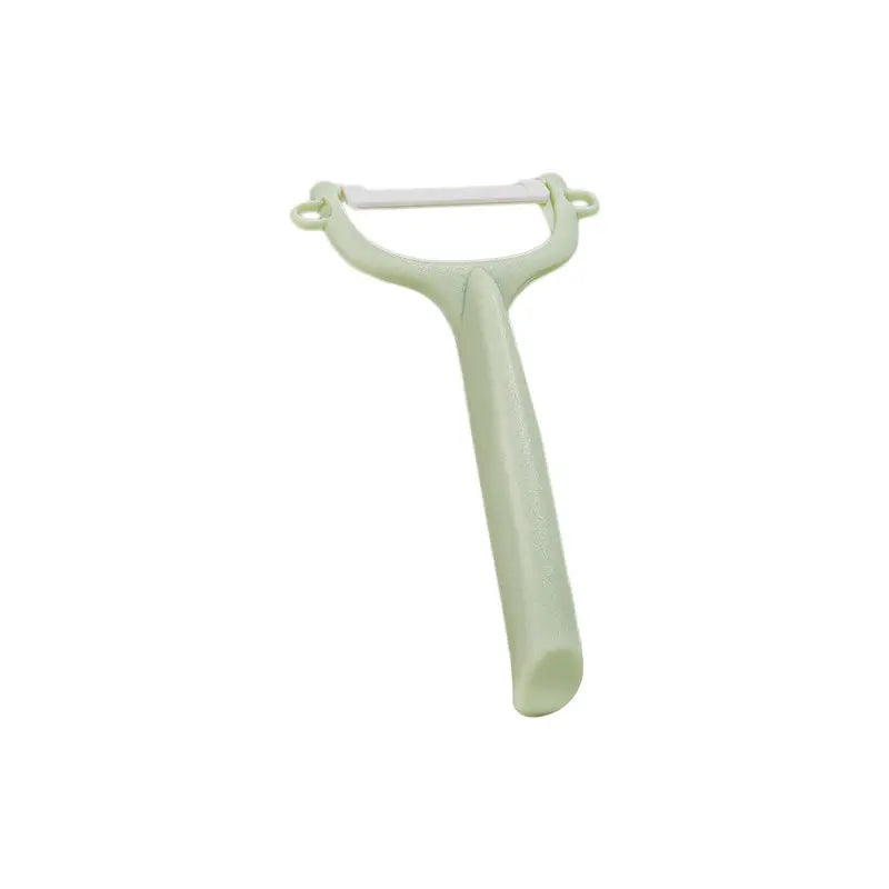 BC Babycare Baby Food Ceramic Peeler in green handle, blade exposed for peeling.
