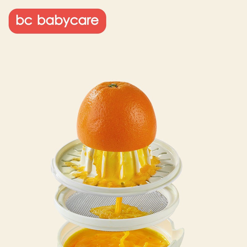 BC Babycare Baby Food Masher with orange fruit on the pressing stack system
