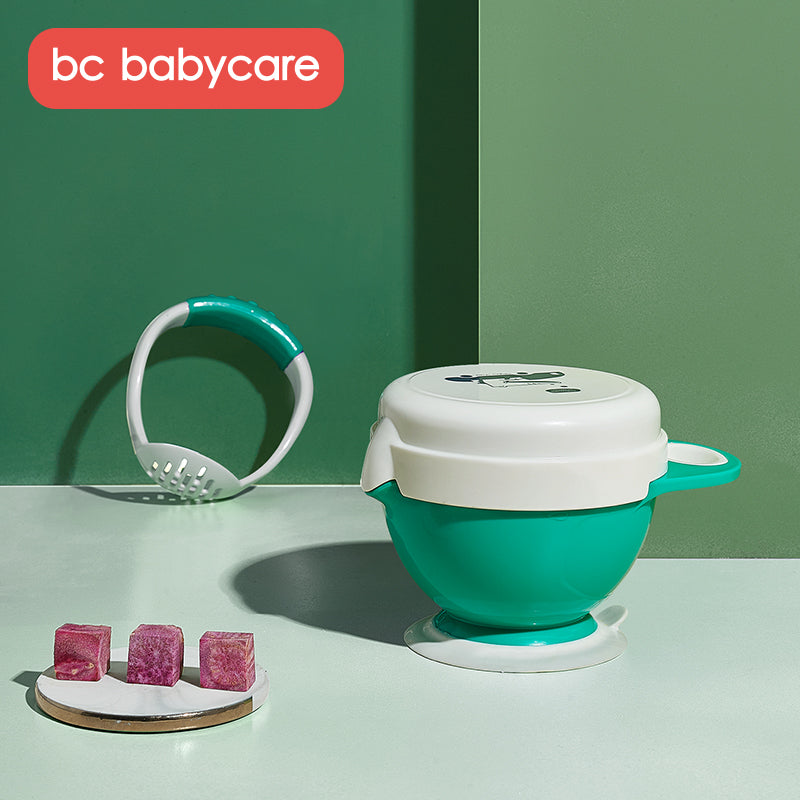 BC Babycare baby food masher in green with white lid and matching green bowl set