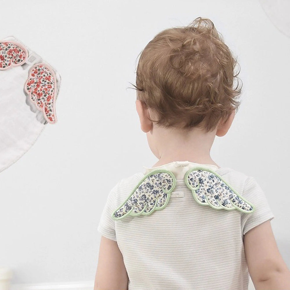 Bc Babycare Baby Gauze winged accessory worn on a toddler, floral print with mint-green trim.