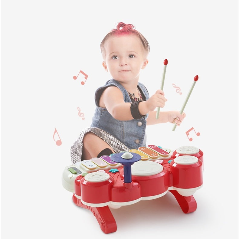 BC Babycare baby piano drum toy with red body and colorful keys; child playing with drumsticks