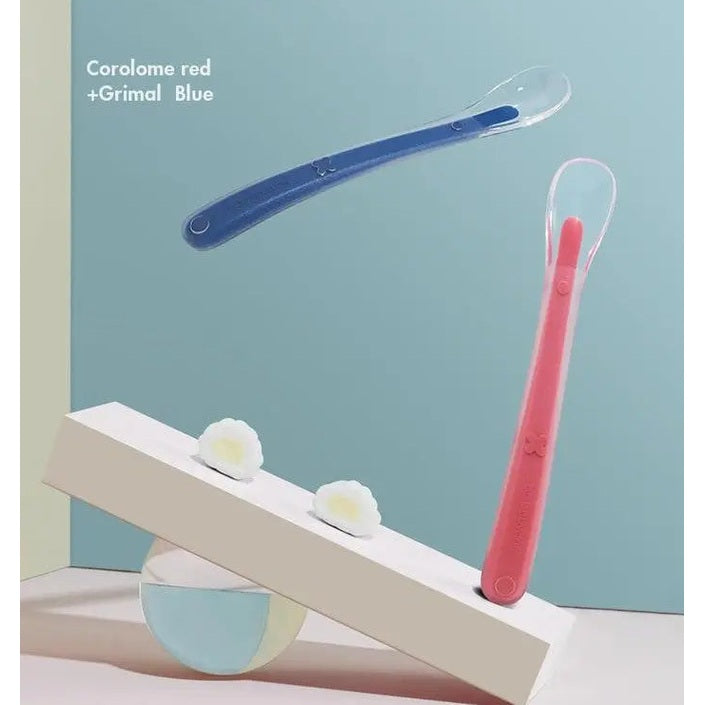 Bc Babycare Baby Silicone Spoon Set, red and blue spoons balanced on a white display block.