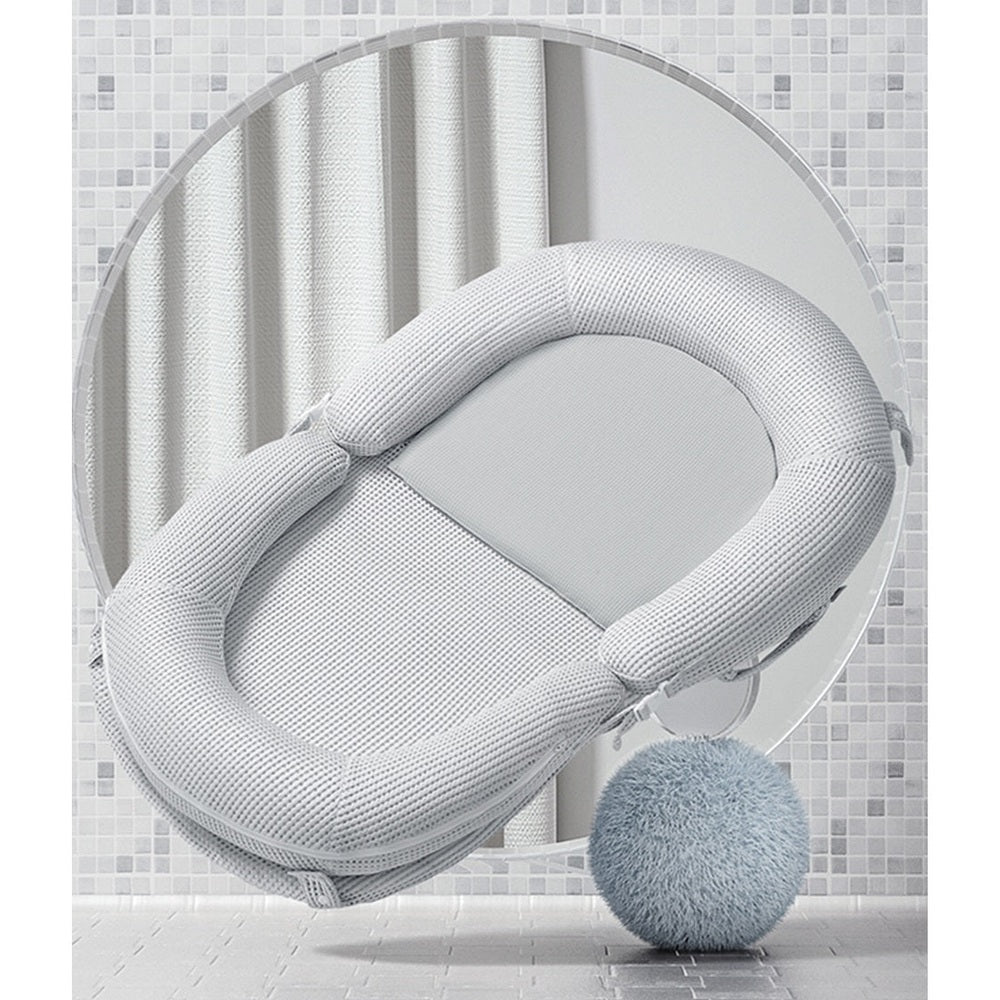 BC Babycare Baby Snuggle Nest in light gray fabric with cushioned ring for newborn comfort