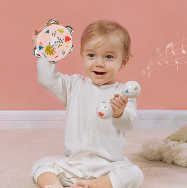 BC Babycare baby tambourine with colorful patterns and two rattling balls, held by a smiling toddler.