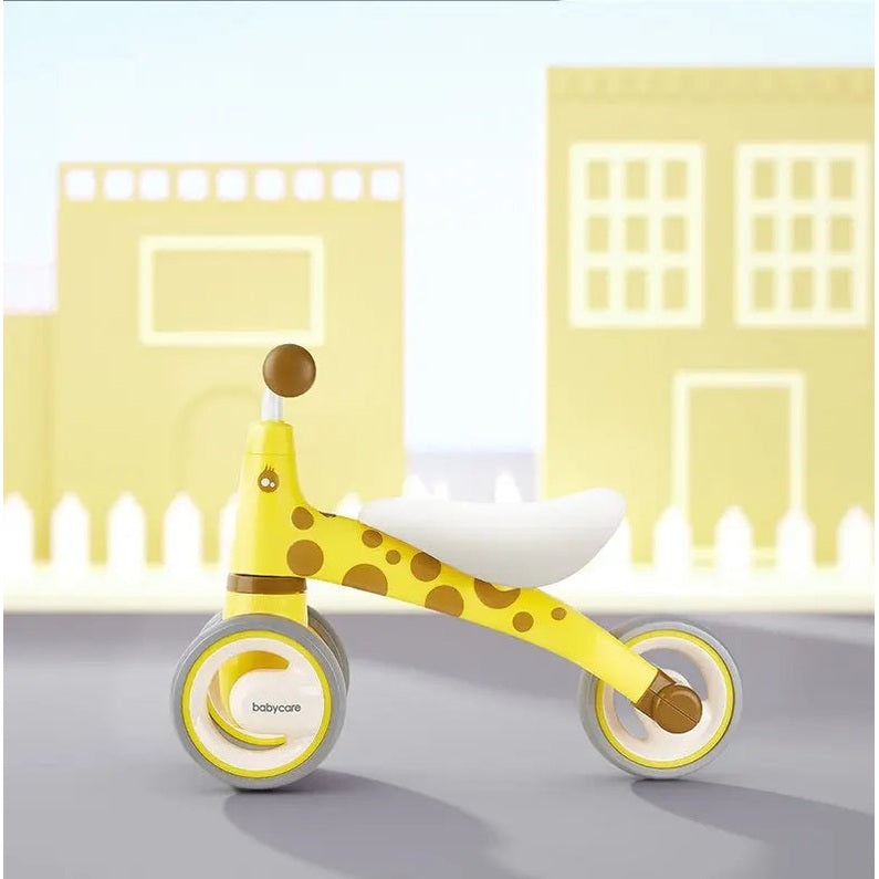BC Babycare Balance Scooter yellow giraffe-pattern ride-on being rolled along with a white seat and gray wheels
