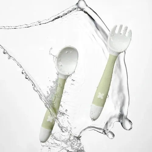 BC Babycare Bendable Spoon & Fork Set (2-piece) in light green handles, flexed to show bendable design