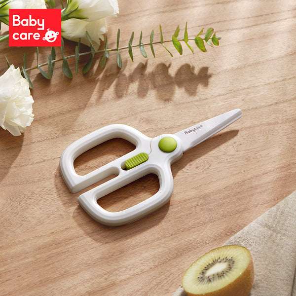 BC Babycare ceramic scissors with safety lock; white handles with green accents