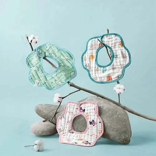 BC Babycare Cotton Flower Shaped Bibs 3Pcs, pastel green/pink/white with teal trim, shown hanging from a branch.