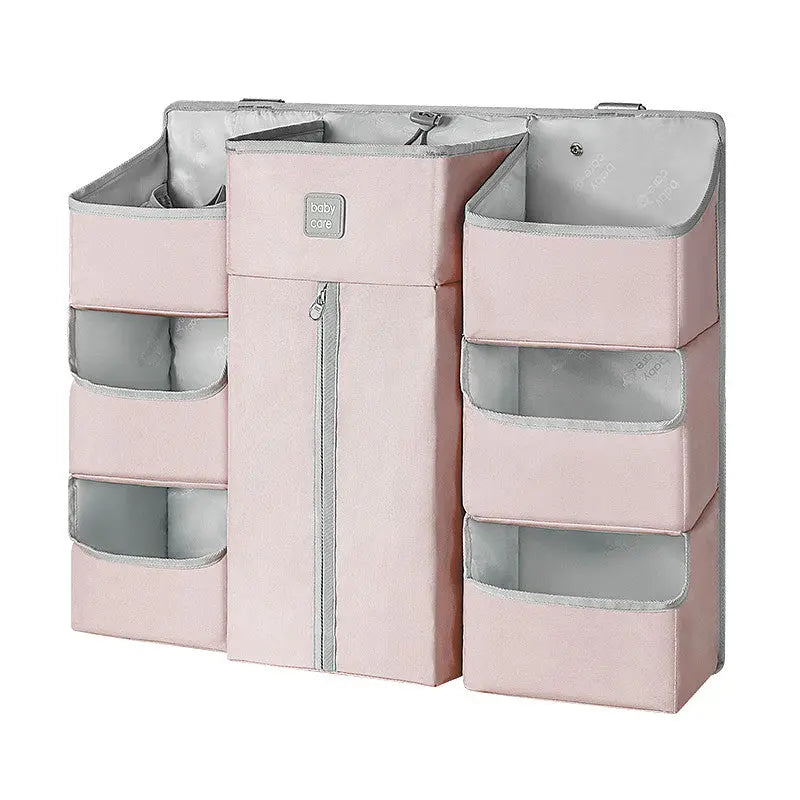 BC Babycare Hanging Storage Bag in pink with clear pockets and a central zip compartment, shown hanging from a closet rod.