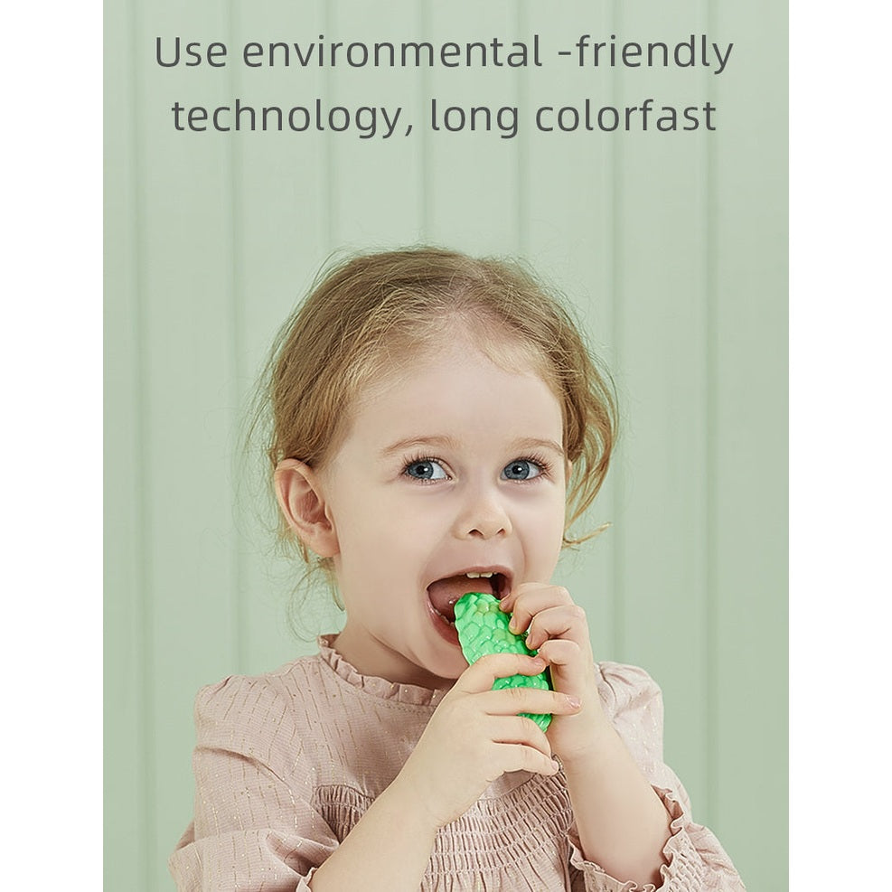 BC Babycare Little Cooker Fruit & Veg toy set, 39pcs, girl chewing a bright green textured vegetable