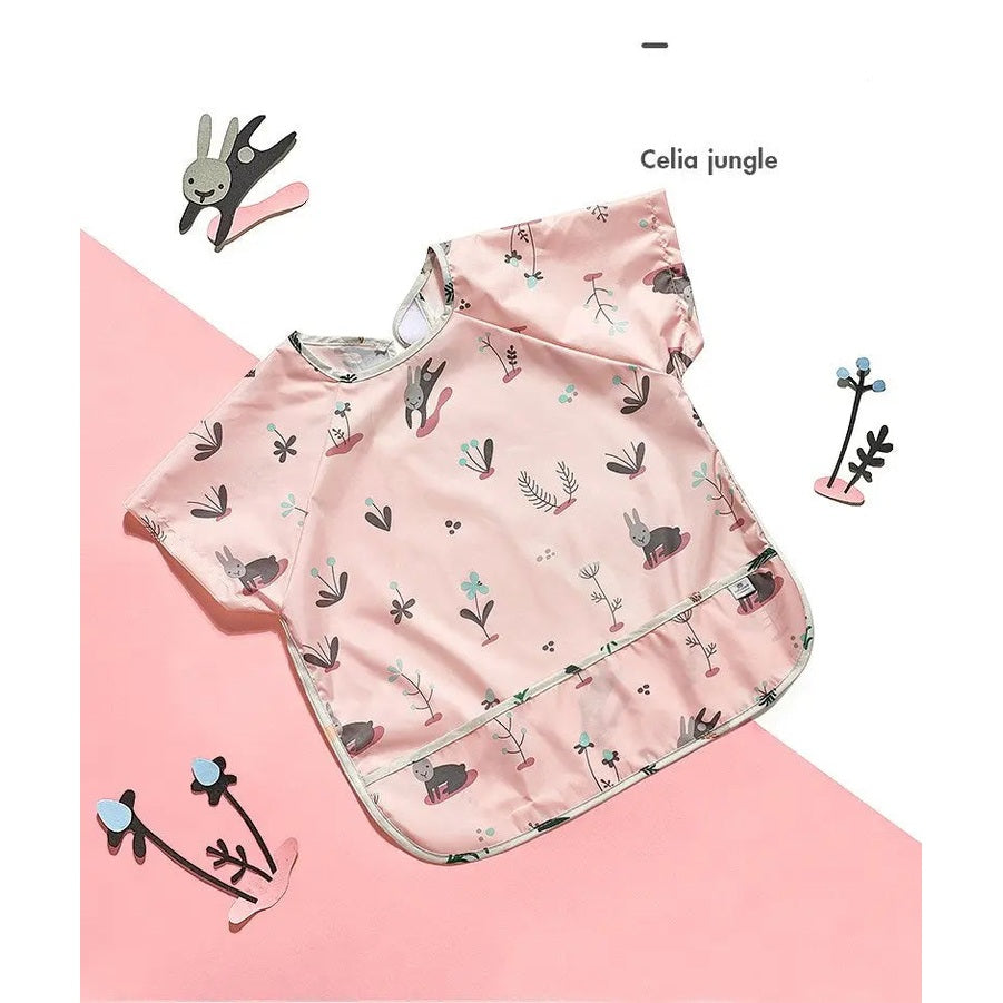 BC Babycare Long Sleeve Bib pink with bunny and plant print, waterproof coating shown laid flat for spill protection.