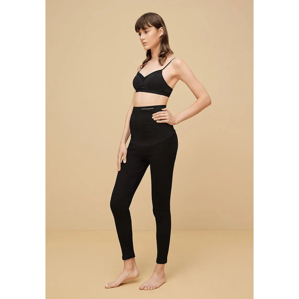 BC Babycare Maternity Leggings Black worn by a pregnant model standing with hands on hips, highlighting the high-waisted, full-length fit.