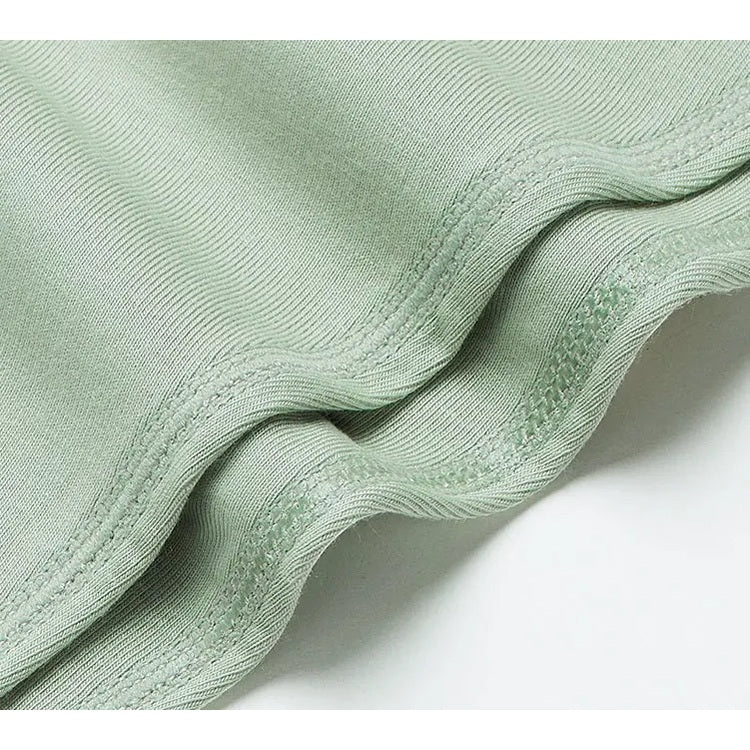 BC Babycare Modal Sleepsuit Green, soft modal fabric with stitched seams shown folded.