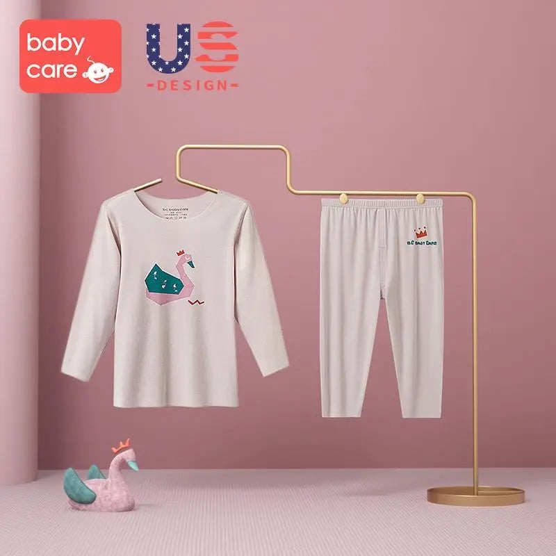 BC Babycare Modal Sleepsuit Pink two-piece set with unicorn-graphic top and matching pants on display rack.