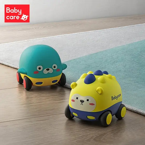 BC Babycare Music & Light Rally Car Toy 2-Set: two bright yellow and teal cars roll on their wheels across a wooden floor.