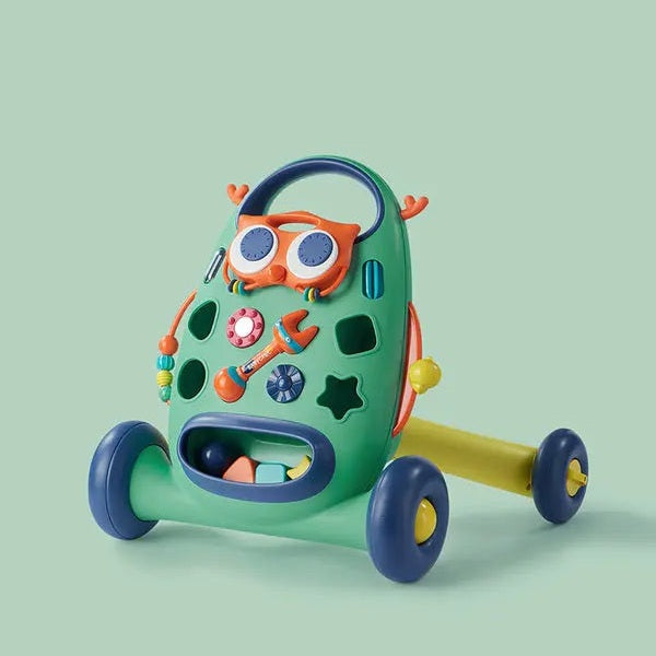 BC Babycare Ride On Walker; green ride-on toy with blue wheels and yellow handle being pushed along.