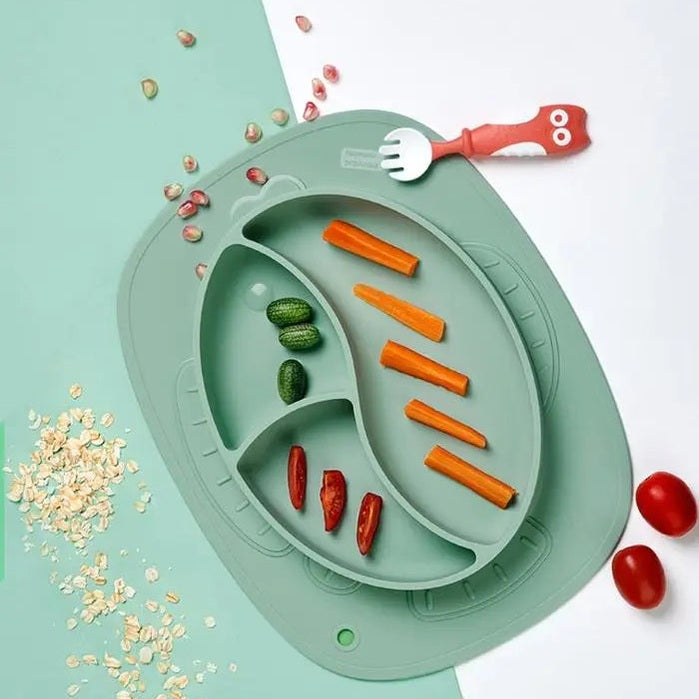 BC Babycare Silicone Anti Slip Plate Fish, green divided plate holding carrot sticks and cucumbers with a red toy fork.