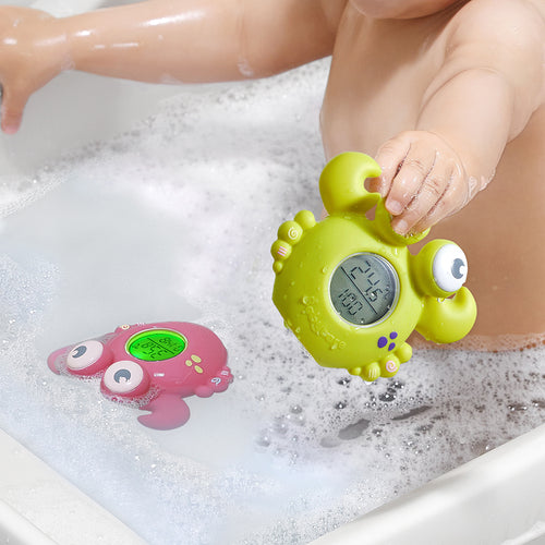 BC Babycare Smart Bath Thermometer green frog with digital display in bubbly bath; pink toy nearby