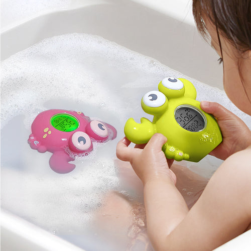 BC Babycare Smart Bath Thermometer green with big eyes; pink bath toy with display nearby in soapy water (2 items)