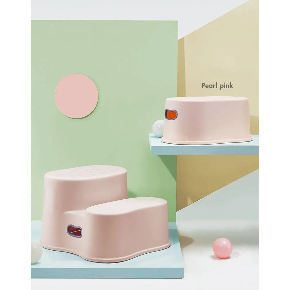 BC Babycare Step Stool in pearl pink, two pastel stools on a blue display, with a side grip cutout.