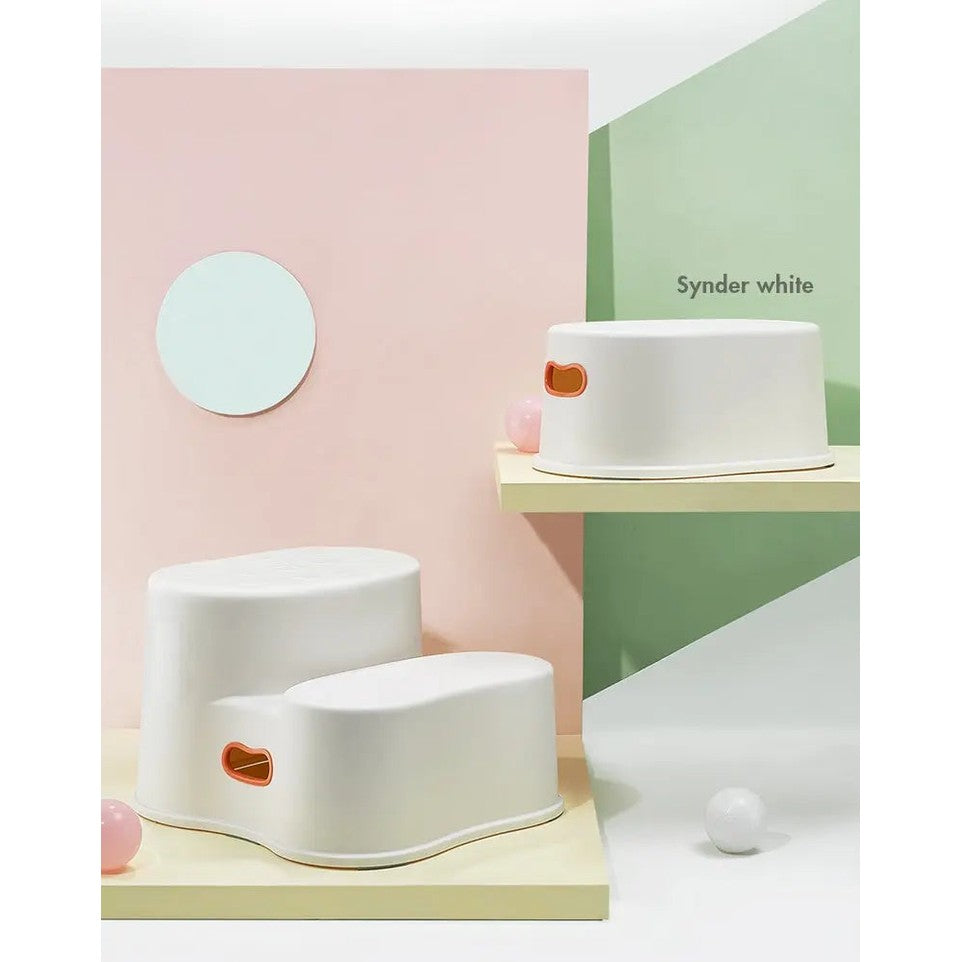 Bc Babycare Step Stool in white with orange handle openings, shown on pastel display for toddlers' stepping.