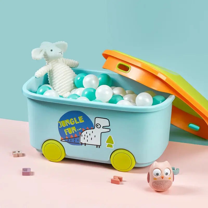BC Babycare Toy Storage Box on wheels, teal body with yellow wheels and orange lid, filled with teal and white balls plus a plush mouse inside