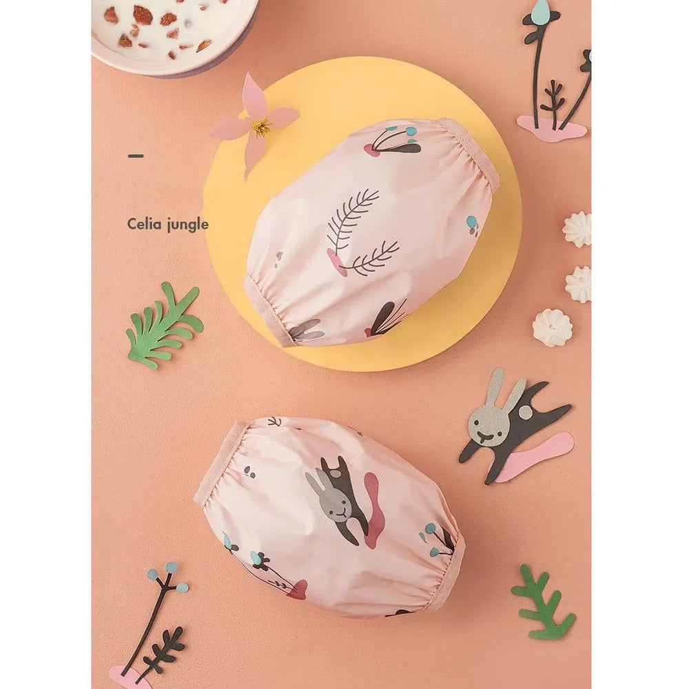 BC Babycare Waterproof Arm Sleeve set, pink botanical prints, two sleeves on peach background ready to protect during meals.