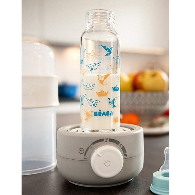 Beaba Ultra Fast Bottle Warmer Cloud with a BEABA glass baby bottle featuring blue and orange crane prints