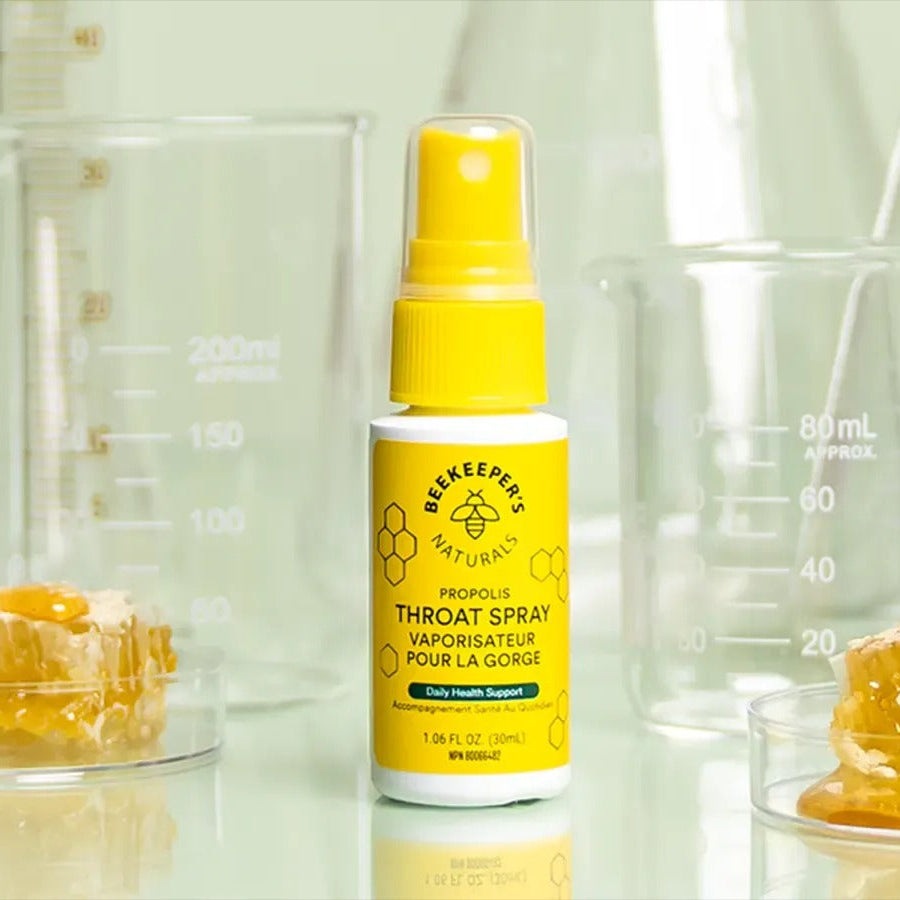 Beekeeper's Naturals Propolis Throat Spray 30 ml bottle with yellow label, spray nozzle ready to dispense.