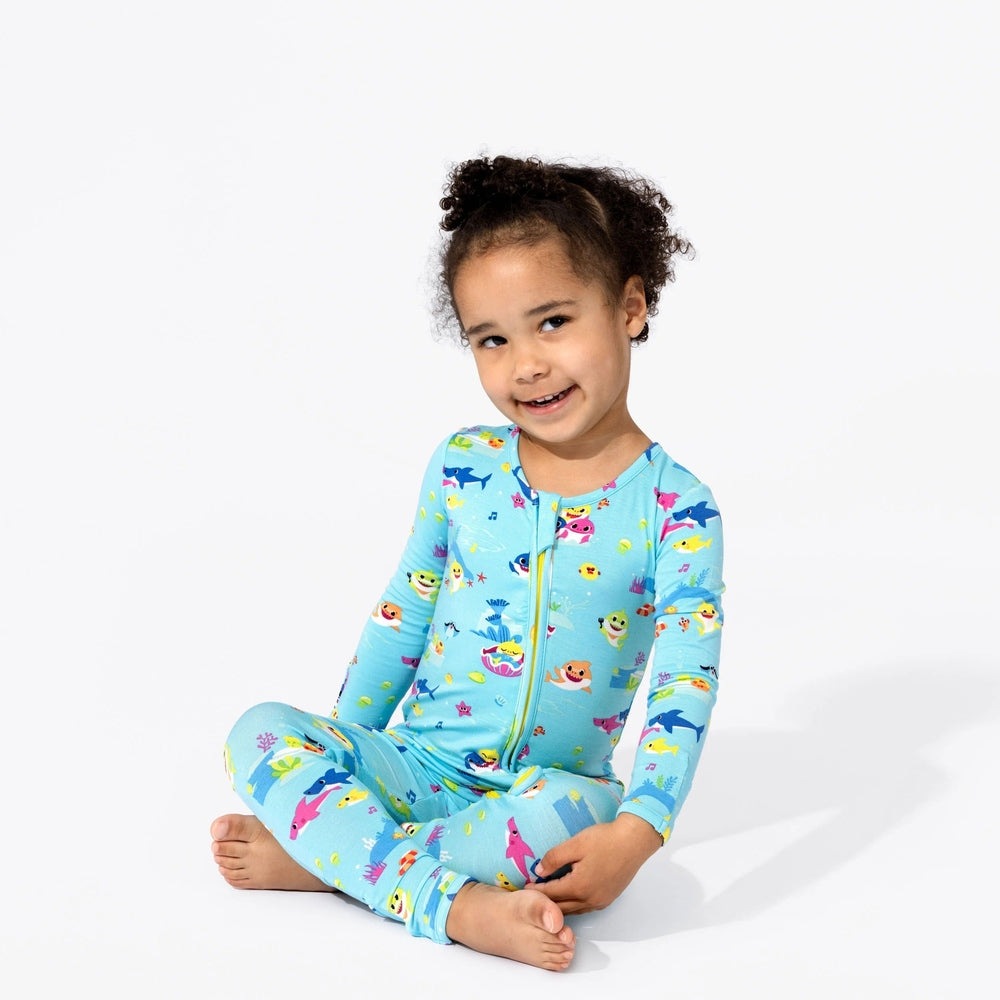 Bellabu Bear Bamboo Convertible Footie Baby Shark worn by a smiling toddler in a blue zipper-front sleeper with underwater prints.