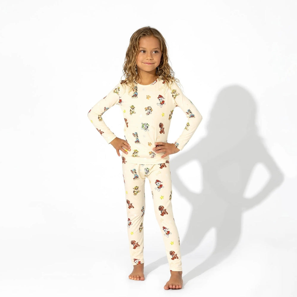 Bellabu Bear Bamboo Kids Pajamas Paw Patrol set in cream; girl stands with hands on hips, showing cozy bamboo sleepwear.