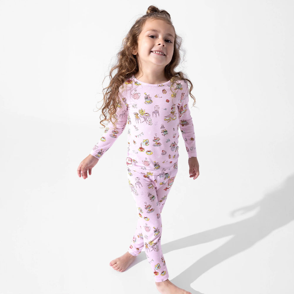 Bellabu Bear Bamboo Kids Pajamas Tea Party set in pink; a smiling girl walks in matching long-sleeve top and leggings.