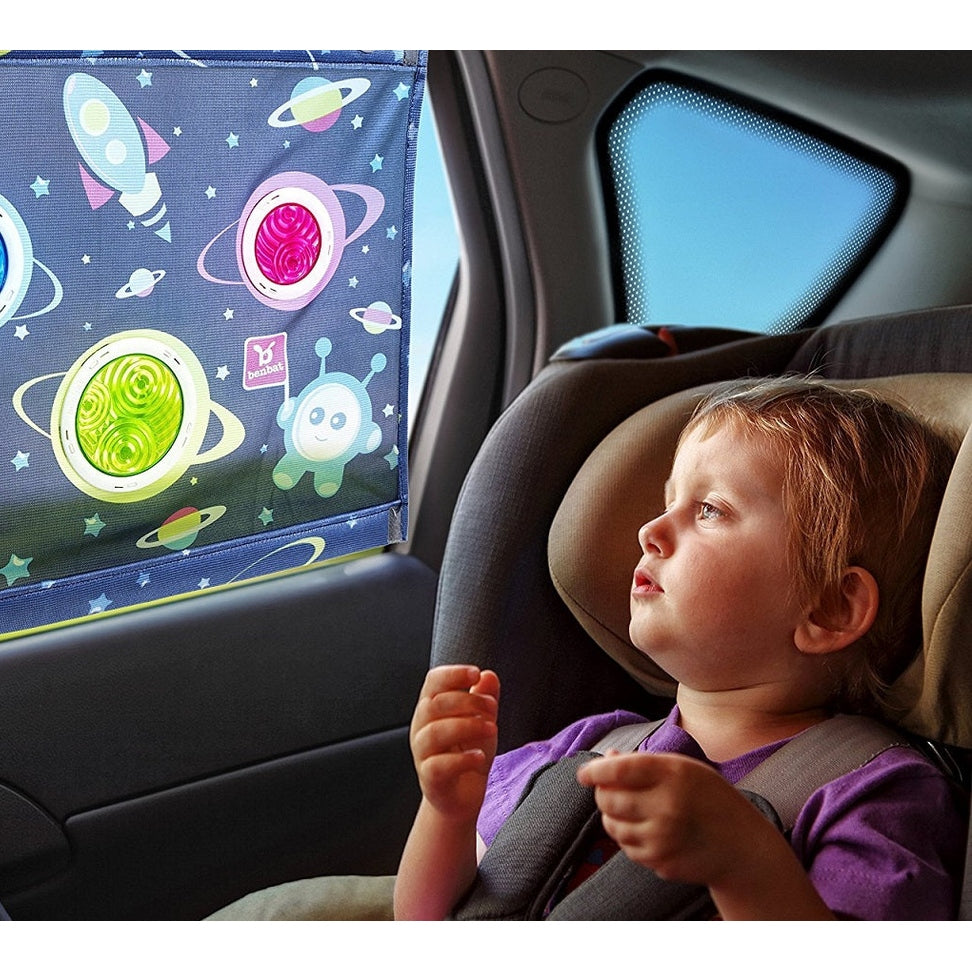 Benbat Car Sunshade With Dazzle Effect Square Shape With Hanger hung on a car window, toddler in car seat gazes outside.