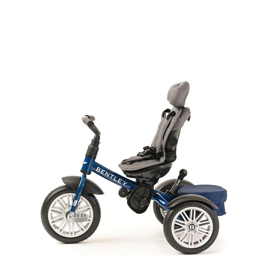 Bentley Trike 6-In-1 V2 Sequin Blue toddler tricycle with adjustable seat, harness, and rear storage bag
