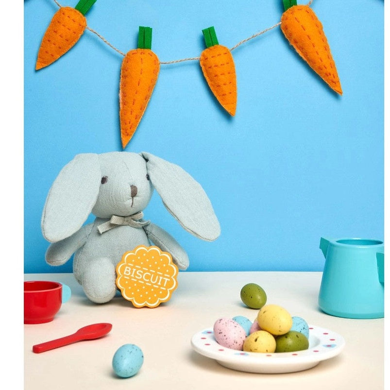 Best Years cotton bunny plush toy in teal with carrot garland and pastel eggs display