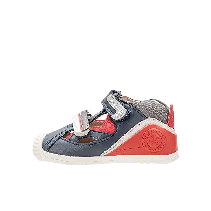 Biomecanics A Azul Marino toddler sandal with navy upper, red heel panel, and Velcro straps fastened.