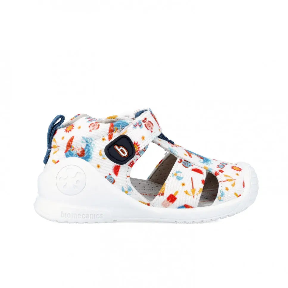 Biomecanics Canvas Sandals Blanco, white with colorful print, Velcro strap fastening on a toddler's foot.