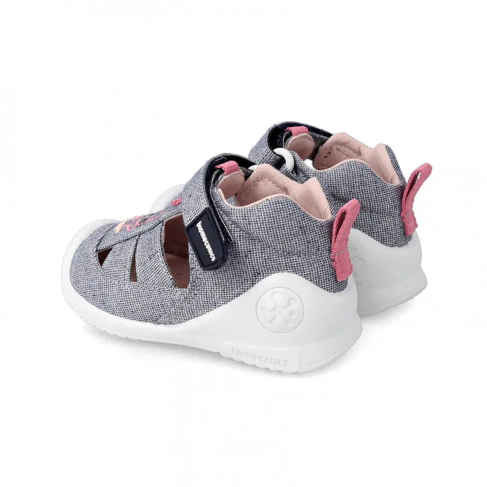 Biomecanics First Steps Sandals Shoes Grey for toddlers, pair with pink lining, adjustable Velcro straps and white chunky outsole.