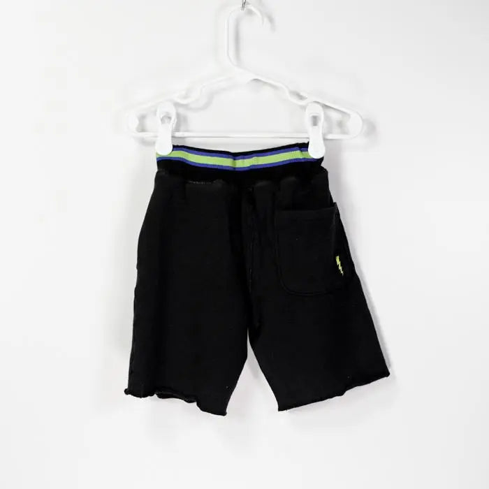 Bit'z Kids Lightning Printed Shorts on a hanger, black with neon blue/green waistband and front pocket.