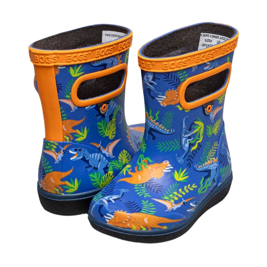 BOGS Skipper II Dinosaur Jungle Blue Multi toddler boots; two blue dinosaur-print waterproof rubber shoes with orange trim.