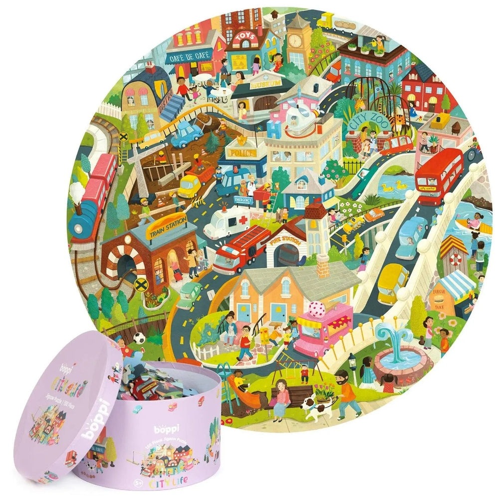 Boppi 150 Piece Kids Round Jigsaw Puzzle with a vibrant cityscape, kids assembling pieces beside the purple box.