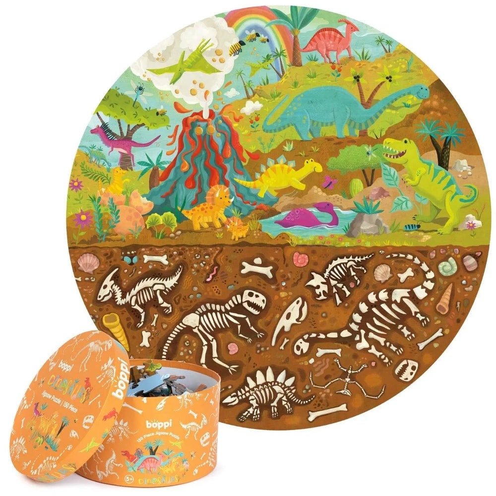 Boppi 150-Piece Kids Round Jigsaw Puzzle, round orange tin shown, featuring vibrant dinosaurs above ground and fossils below.
