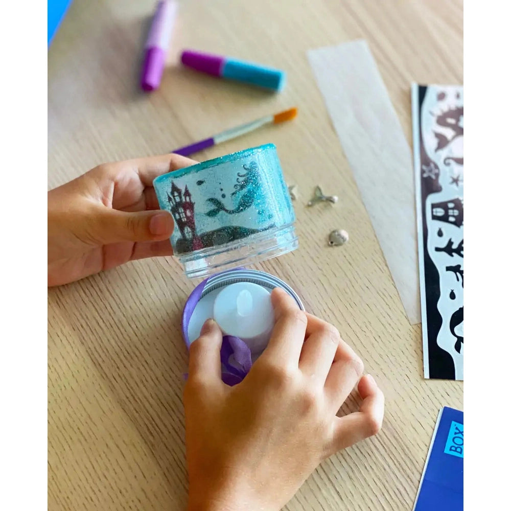 Box Candiy Totally Twilight candy tin with blue glitter lid and purple ribbon inside, held by hands
