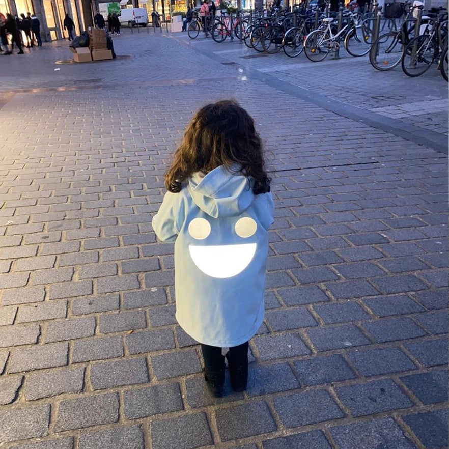 Baby wearing Boxbo Wistiti Fleece Lined Waterproof & Snowproof Fur Jacket Misty Ice Blue, hood up, large white smile on back.